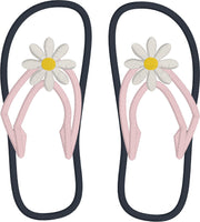 An applique of flip-flops with a daisy embroidered on them. by snugglepuppyapplique.com