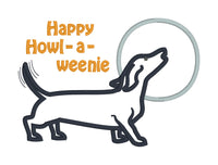 an applique of a dachshund howling at the moon and the words "Happy Howl-a-weenie" by snugglepuppyapplique.com  Edit alt text