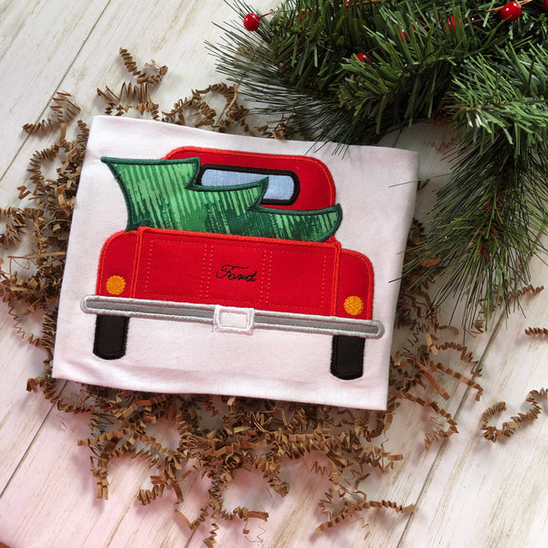 Christmas tree in the back of a pickup truck bed applique machine embroidery design by snugglepuppyapplique.com
