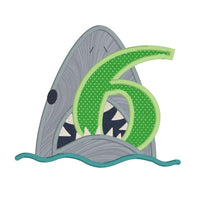 an applique of a shark biting the number 6 by snugglepuppyspplique.com
